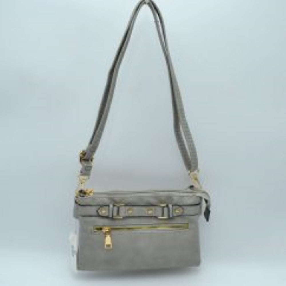 Gray This functional crossbody bag is designed for organized everyday use, featuring a textured exterior equipped with multiple secure storage compartments. The front panel includes a convenient horizontal zippered pocket accented with an oversized metallic zipper pull, situated beneath a decorative horizontal band detailed with metallic studs and loops.