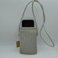 Gray This compact vertical crossbody bag is designed for everyday functionality with a distinct woven textured pattern across its body. It features a slim, continuous cord strap attached securely to the sides with visible knot details for comfortable carrying. A clean horizontal opening at the top allows effortless access to the main storage compartment