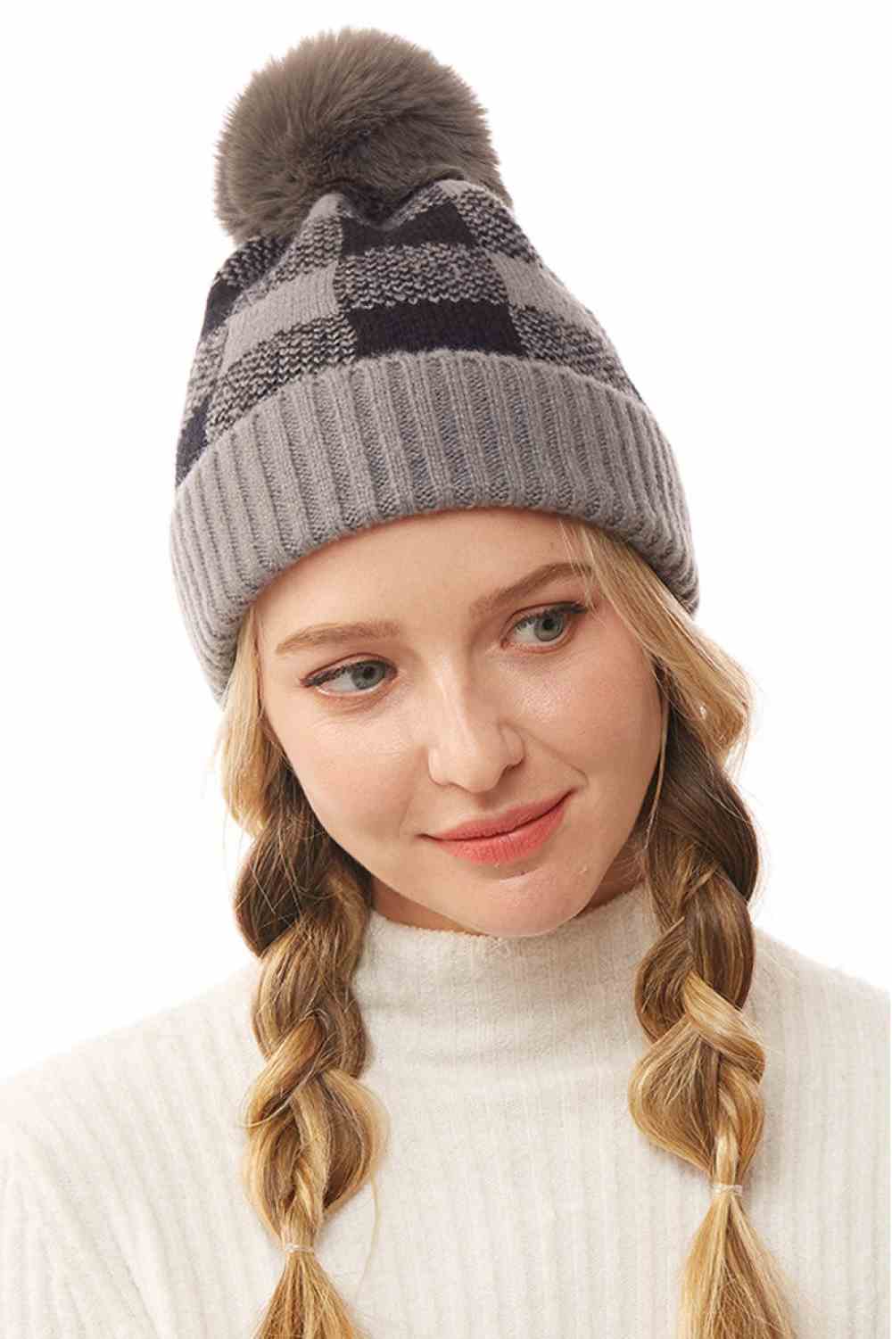Gray The Buffalo Check Beanie with Pom Pom features a classic plaid design that brings timeless style to your winter wardrobe. Made from soft, cozy knit fabric with a playful pom pom accent, it offers warmth, comfort, and a snug fit for chilly days.