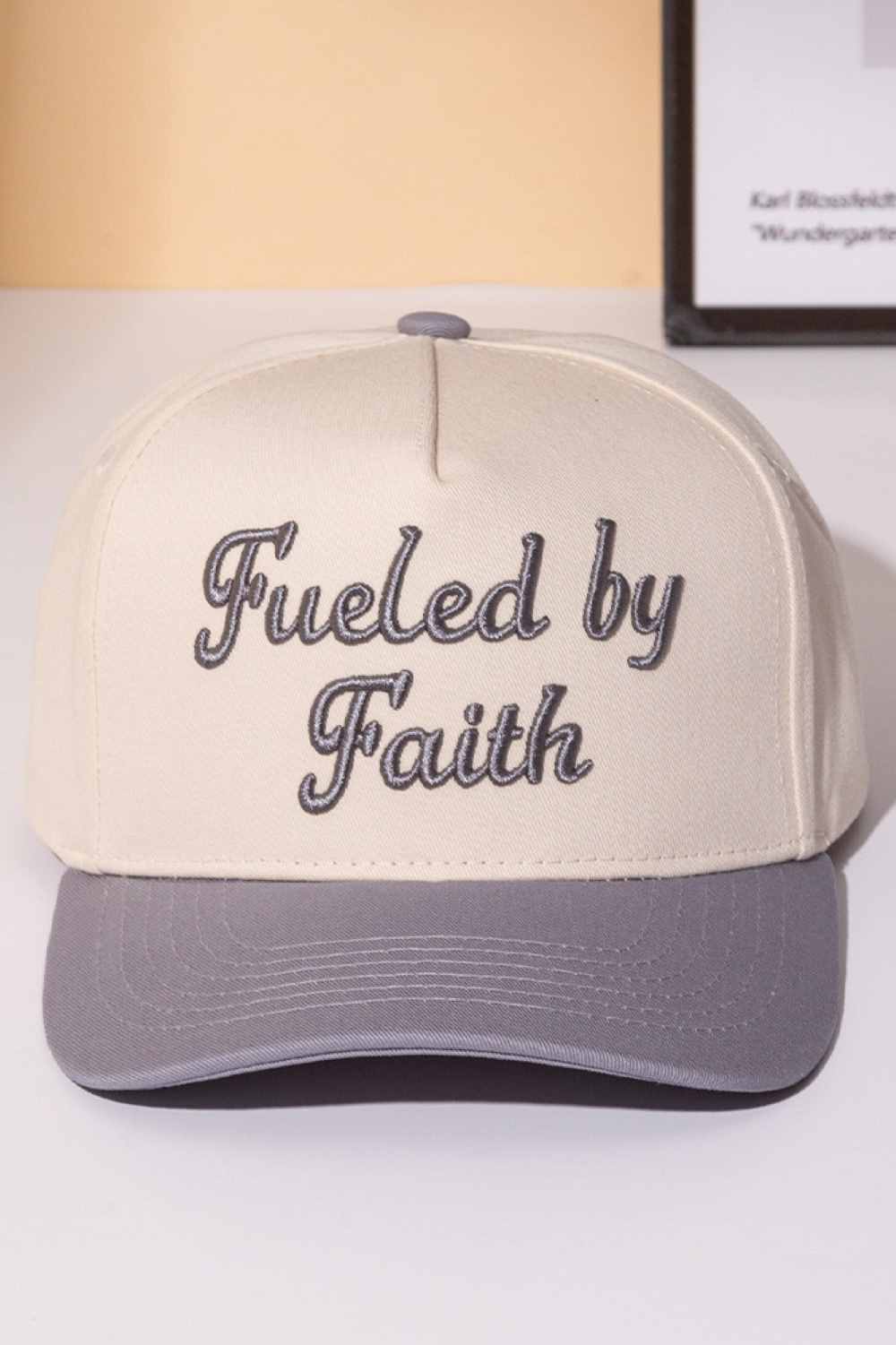 Gray Declare your faith with style in this classic two-tone trucker cap. Featuring bold embroidered lettering that reads "FUELED BY FAITH," this snapback combines comfort with meaningful expression. Crafted from 100% cotton, it's breathable and lightweight for all-day wear. The adjustable snapback closure ensures a perfect fit for one size fits most. Whether you're heading to church, the gym, or casual outings, this cap makes a statement about what drives you. Perfect for believers who wear their conviction