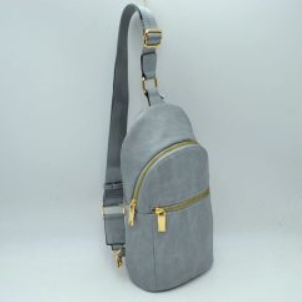 Gray This practical sling bag features a textured, grained finish exterior engineered for active everyday use. It provides multiple tiered storage compartments, including a curved main zippered section and a smaller, secondary horizontal zippered front pocket to keep essentials organized. The bag is designed with a single wide shoulder strap style that connects through a square metallic loop and includes an integrated adjustment buckle to alter the carrying length easily.