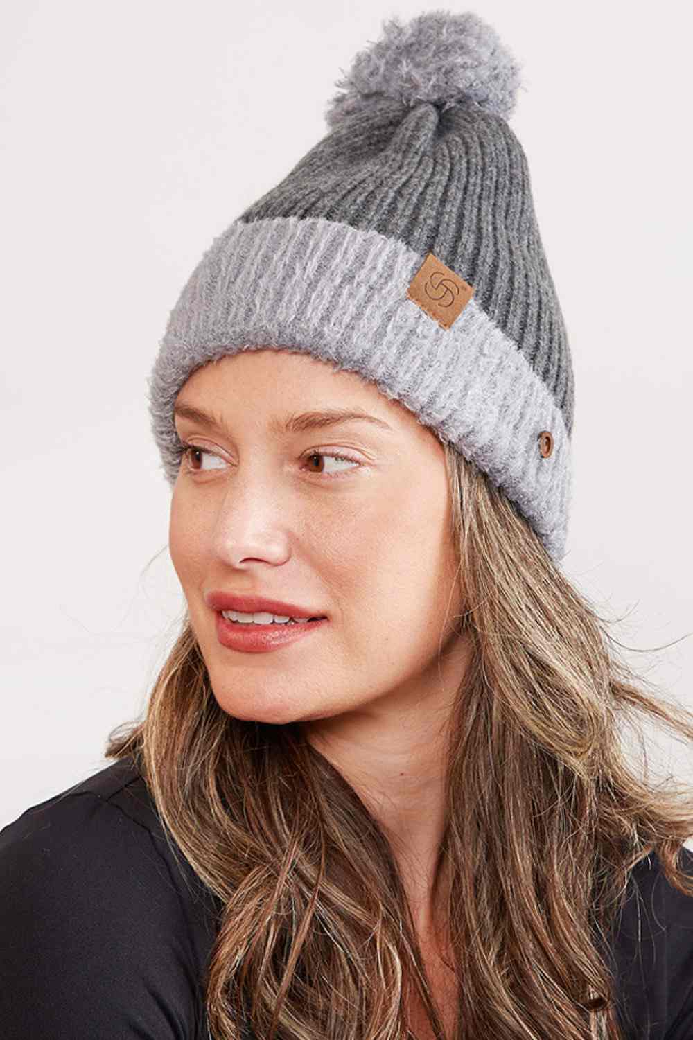 Gray Cozy up this season with our Ribbed Brim Button Pom Beanie, designed for warmth and style. Crafted from 100% acrylic, this soft knit hat features a classic ribbed texture, decorative buttons, and a charming pom pom on top.