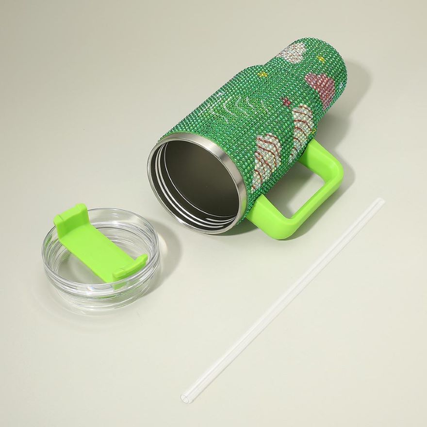 Celebrate the holidays with this 40oz rhinestone tumbler featuring festive Christmas tree and ornament designs. Includes a handle and straw for easy sipping. A sparkling addition to your seasonal drinkware or gift list.