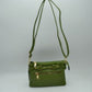 Green This functional crossbody bag is designed for organized everyday use, featuring a textured exterior equipped with multiple secure storage compartments. The front panel includes a convenient horizontal zippered pocket accented with an oversized metallic zipper pull, situated beneath a decorative horizontal band detailed with metallic studs and loops.