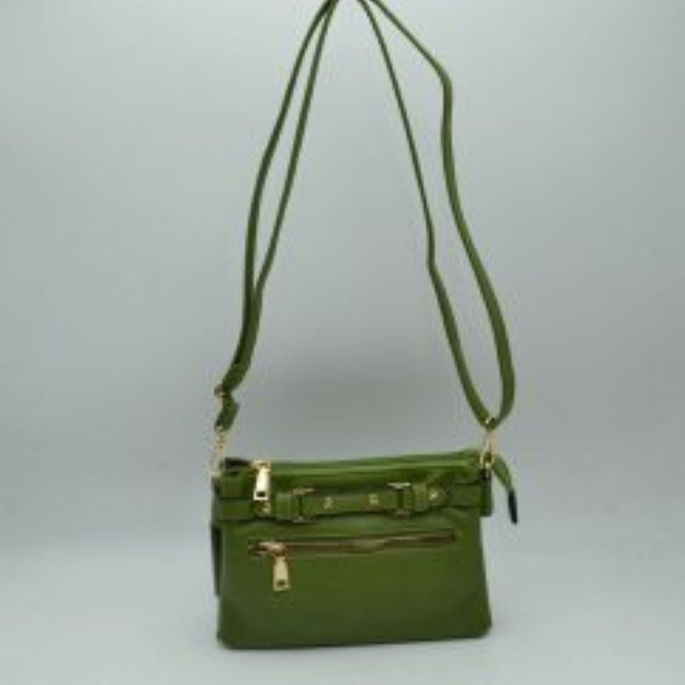 Green This functional crossbody bag is designed for organized everyday use, featuring a textured exterior equipped with multiple secure storage compartments. The front panel includes a convenient horizontal zippered pocket accented with an oversized metallic zipper pull, situated beneath a decorative horizontal band detailed with metallic studs and loops.