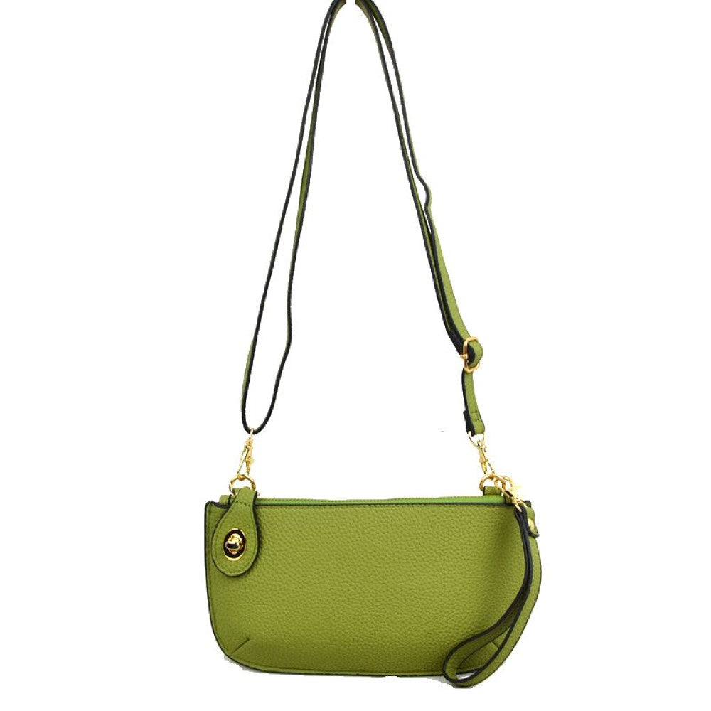 Green This versatile everyday bag features a compact pebbled textured body with a slightly curved base silhouette. Designed for organized daily or evening use, the main storage compartment is secured by a top zipper closure and accented with a small decorative metallic turn-lock detail on the side panel. It offers multiple carrying options, equipped with a long, adjustable crossbody shoulder strap and a shorter matching wristlet loop