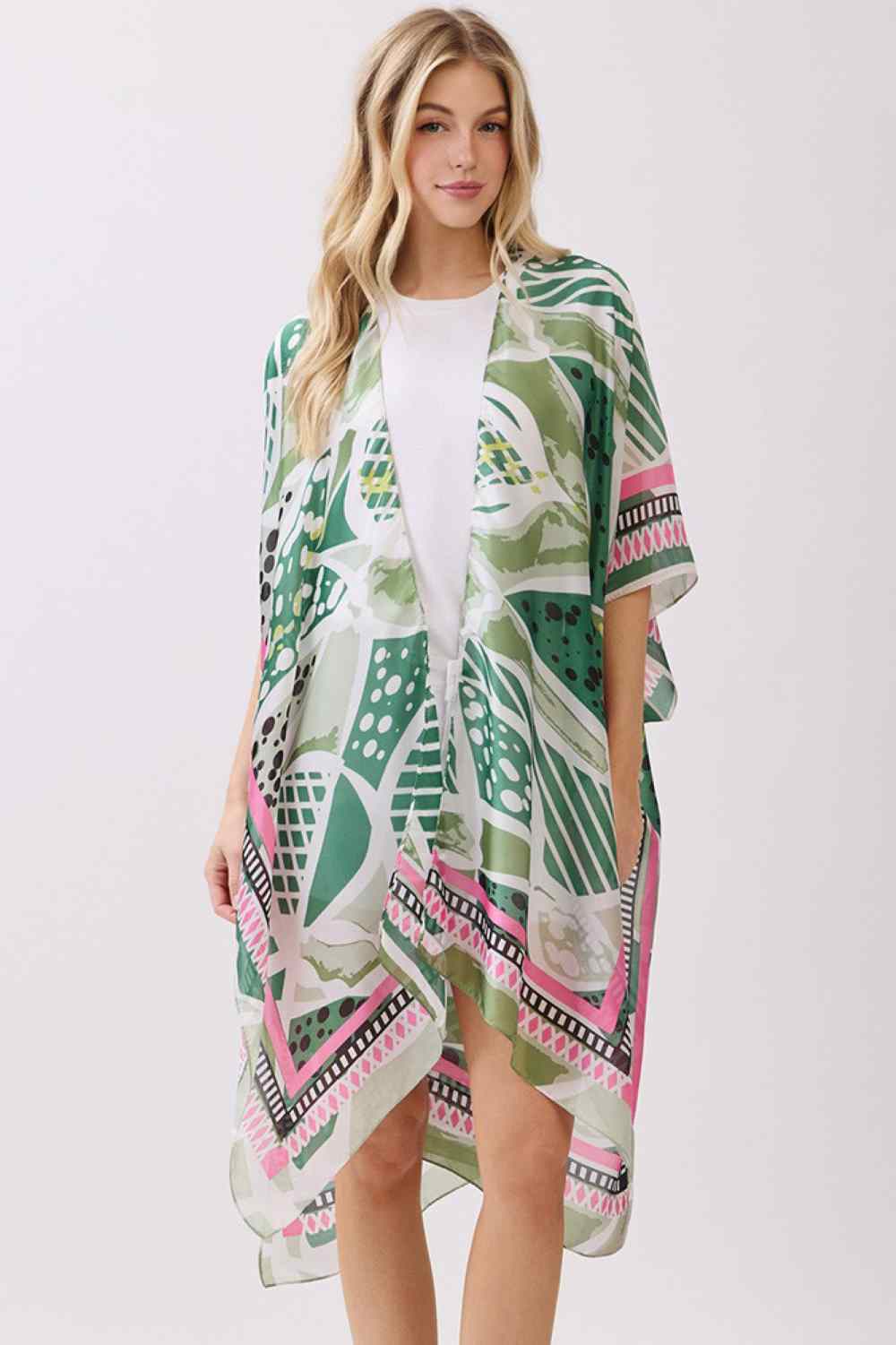 Green Effortless elegance meets comfort in this abstract botanical kimono cover-up. Featuring a striking botanical print with decorative pattern edges, this lightweight piece drapes beautifully over any outfit. The silky polyester fabric feels luxurious against skin while maintaining easy care. Perfect for layering at the beach, poolside, or casual outings. Dimensions: 35" x 36". 100% polyester. Made in China.