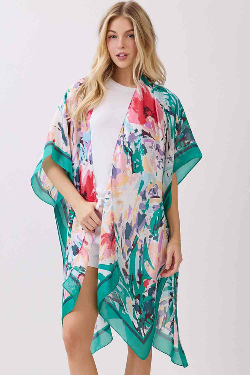 Green Effortless elegance meets comfort in this abstract floral kimono cover-up. Crafted from 100% polyester with a luxuriously silky feel, it features a vibrant floral print accented by solid color edges for a polished look. Perfect for layering over swimwear, loungewear, or casual outfits, this versatile piece transitions seamlessly from beach to brunch. Generous 35" x 36" dimensions provide flattering coverage and easy movement. An essential wardrobe staple for any season.