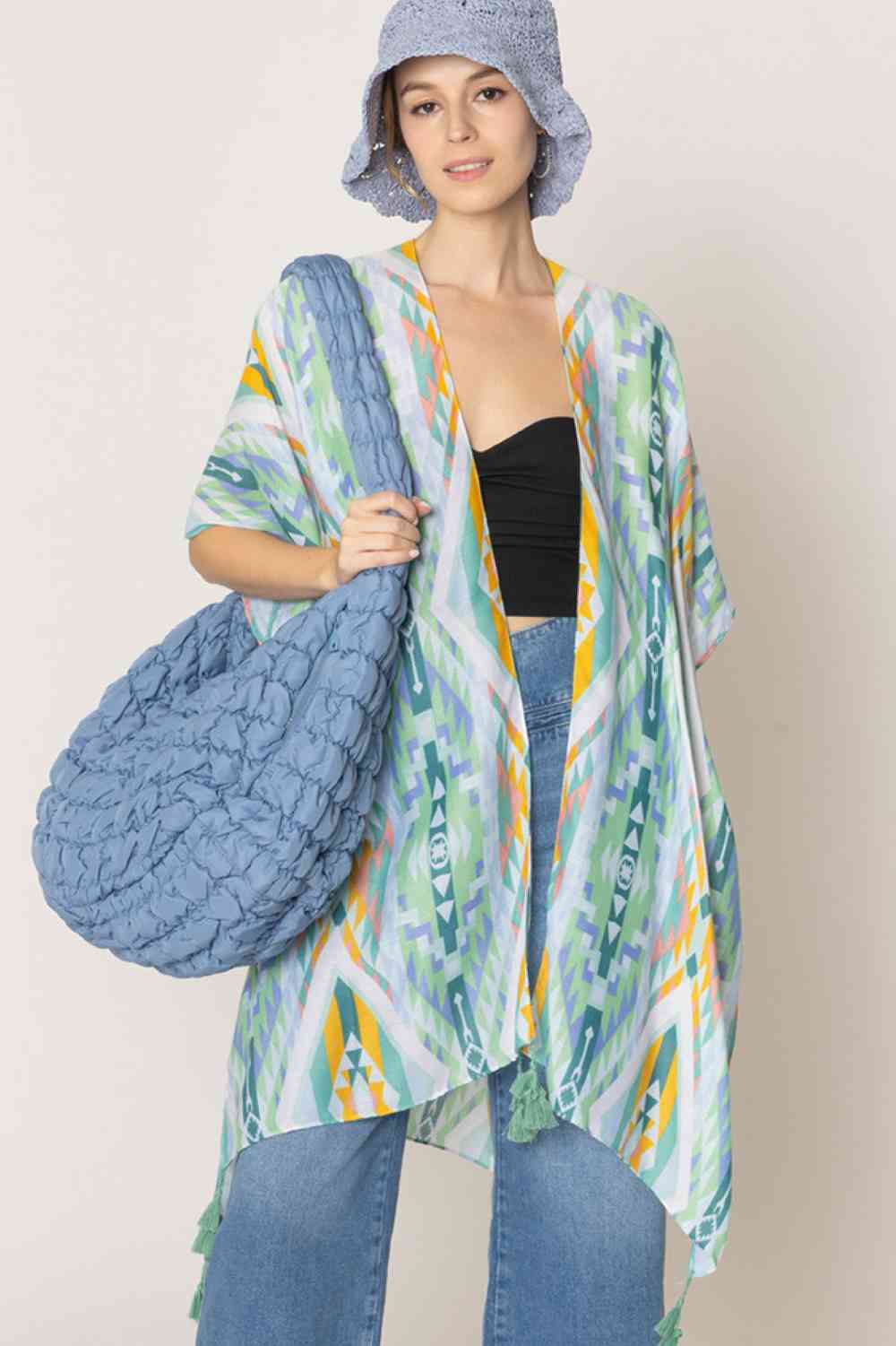 Green Embrace bohemian style with this striking Aztec Pattern Print Tassel Kimono. Crafted from lightweight 100% polyester, this versatile piece features bold geometric patterns inspired by traditional Aztec designs, complete with decorative tassels for added flair. Perfect for layering over dresses, swimwear, or casual outfits, it offers effortless coverage and movement. With generous dimensions of 35.4" x 35.4", it drapes beautifully on most body types. Ideal for beach days, festivals, or relaxed everyday
