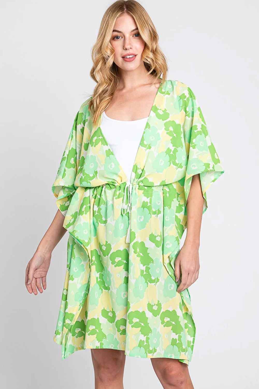 Green Effortless beach style meets playful charm with this Daisy Tie Drawstring Open Front Cover Up. Crafted from lightweight 100% polyester, this versatile piece features an open front design with adjustable tie drawstring closure for a customizable fit. Perfect for layering over swimwear or casual outfits, the relaxed silhouette offers comfort and coverage. Measuring 39" x 35", it's an ideal companion for poolside lounging, beach days, or resort wear.