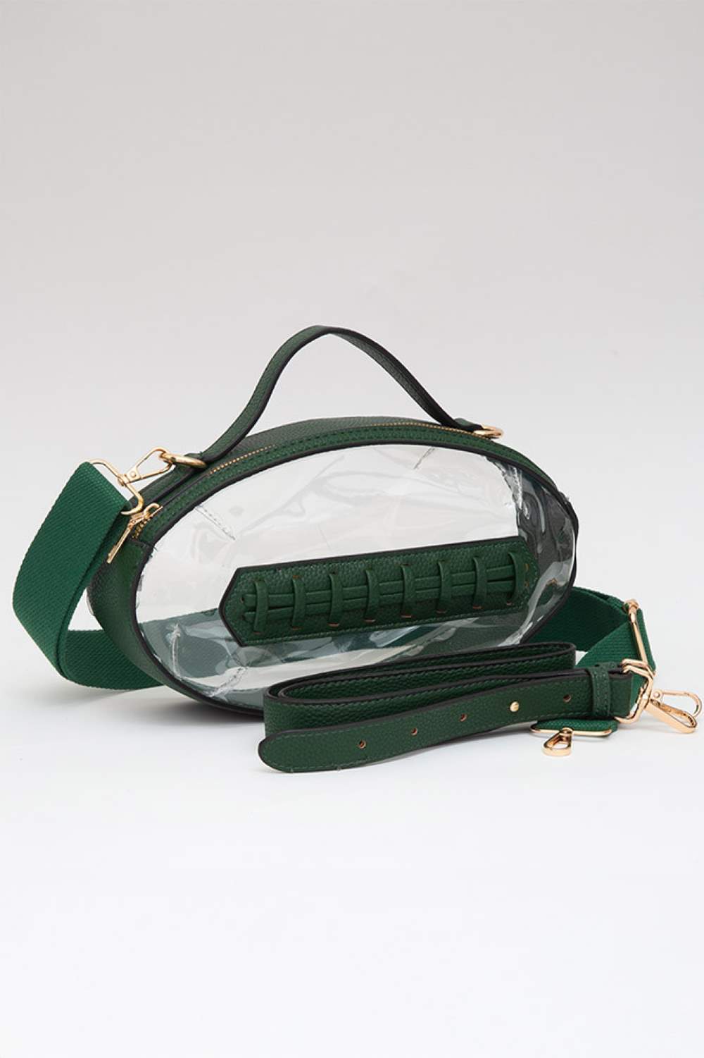 Green Carry your essentials in style with this unique football-shaped transparent crossbody bag. Perfect for stadium events, concerts, and outdoor gatherings, the clear PVC design lets you see everything inside while meeting venue security requirements. Measuring 11" x 6" x 4", it offers practical storage without bulk. The adjustable crossbody strap keeps your hands free, making it ideal for busy days out. Durable 100% PVC construction ensures long-lasting wear through countless adventures.