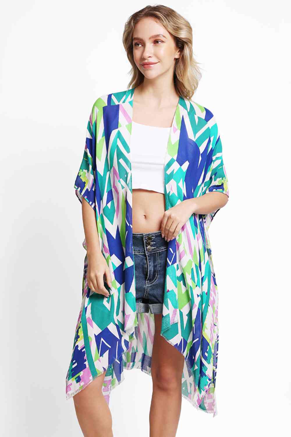 Green Elevate your beach wardrobe with this stunning geometric abstract kimono cover up. Made from breathable 100% viscose, it's the perfect lightweight layer for sun-soaked days. The eye catching abstract pattern brings contemporary flair to any swimwear ensemble. With generous dimensions of 38" x 39", this cover up offers comfortable coverage and an easy, relaxed silhouette. Ideal for transitioning from beach to brunch in effortless style.