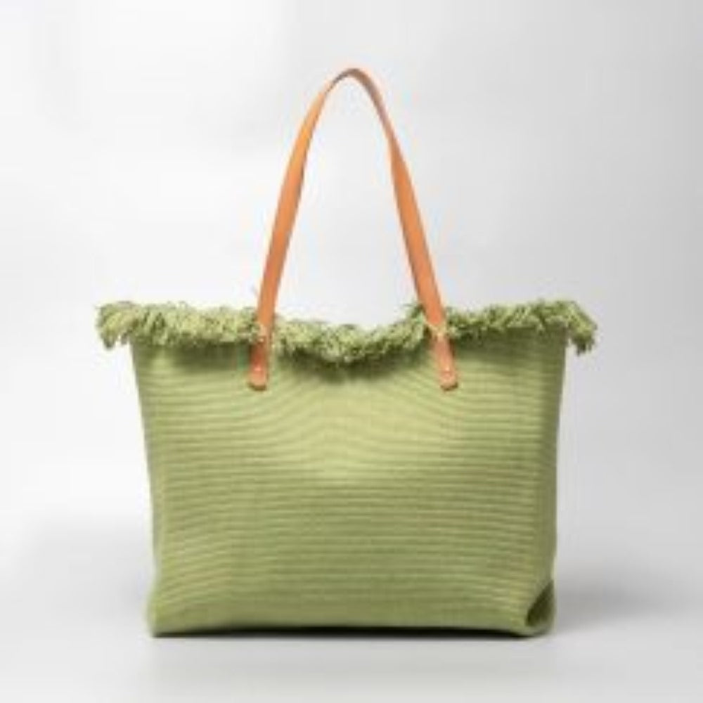 Green This spacious tote bag features a finely textured main body adorned with an eye-catching, voluminous fringe trim entirely wrapping around the upper opening. Designed for versatile everyday use, the bag is equipped with dual flat shoulder straps anchored securely to the front and back panels by metallic rivets.