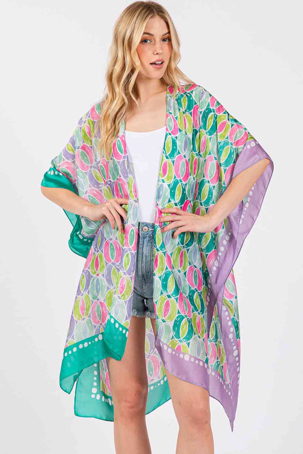 Green Purple Effortless elegance meets summer style with this Two Tones Trim Abstract Pattern Kimono. Crafted from 100% polyester with a luxuriously silky feel, this lightweight cover-up drapes beautifully over any outfit. The striking abstract pattern and contrasting two-tone trim add visual interest and versatility for beach days, poolside lounging, or casual outings. Generously sized at 35" x 36", it offers comfortable coverage and movement. Perfect for layering during warmer months.