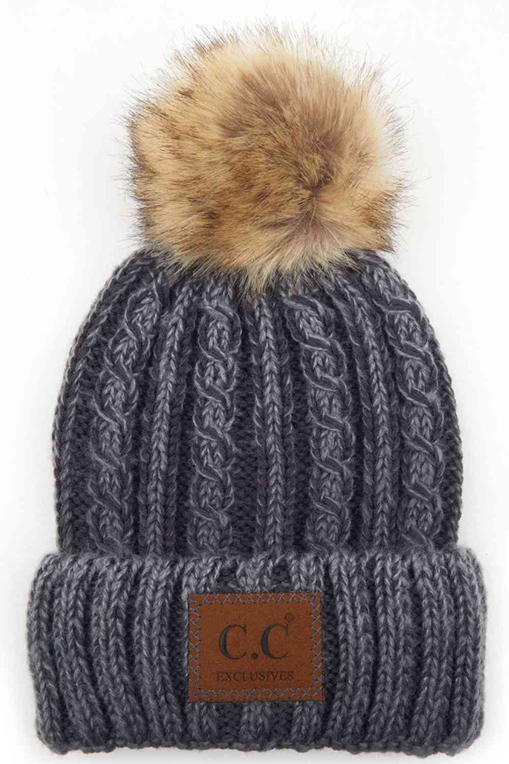 Grey Elevate your winter wardrobe with this C.C ombre beanie featuring a plush faux fur pom. Crafted from 100% acrylic, the soft knit construction provides warmth and comfort without bulk. Perfect for casual outings or layering under winter gear.