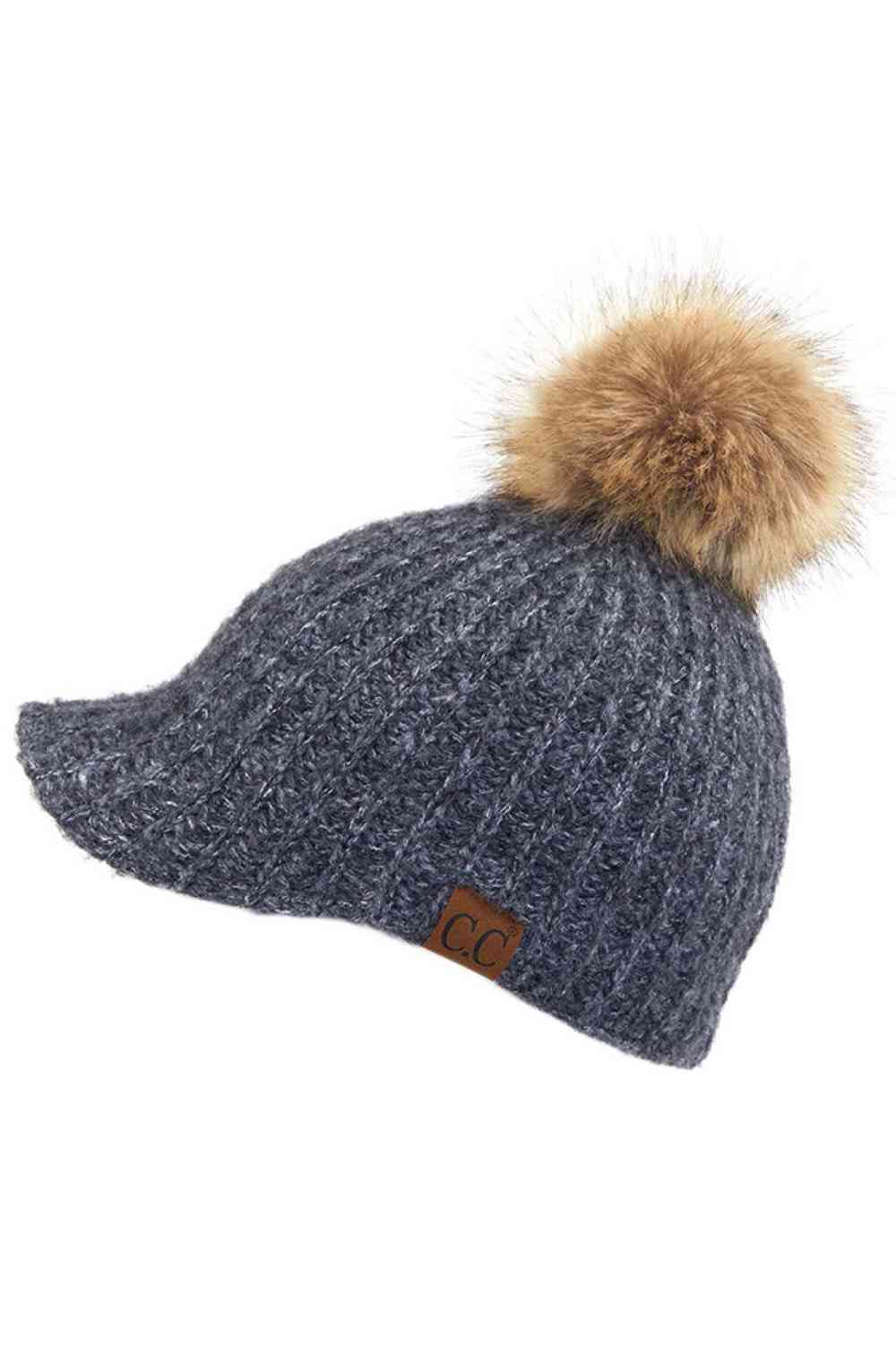 Heather Gray Stay cozy with this knitted brim beanie featuring a plush pom pom detail. Crafted from a soft blend of 75% acrylic, 22% polyester, and 3% spandex, this winter essential delivers warmth and comfort in a versatile style. Available in nine rich colors including Beige, Berry, Dark Denim, Heather Gray, Ivory, Pistachio, Rose, Steel Blue, and Violet Purple. The ribbed knit construction and faux fur pom add texture and visual interest to any cold-weather outfit. Hand wash and lay flat to dry for lasti