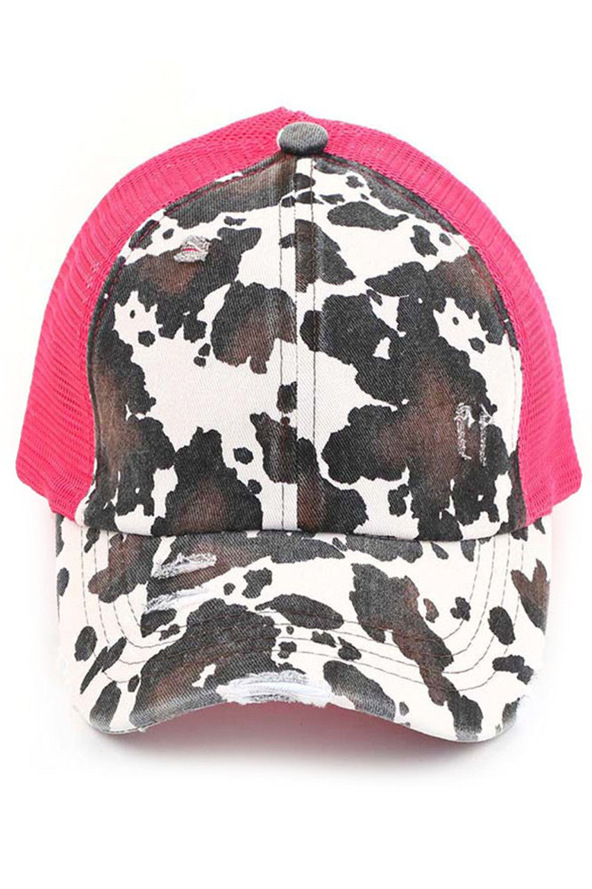 Hot  Pink C.C cow print criss cross ponycap is the perfect blend of style and functionality. The adjustable criss cross design allows for a comfortable and secure fit, while the unique cow print pattern adds a touch of fun to any outfit. Made with high-quality materials, this ponycap is durable and long-lasting.