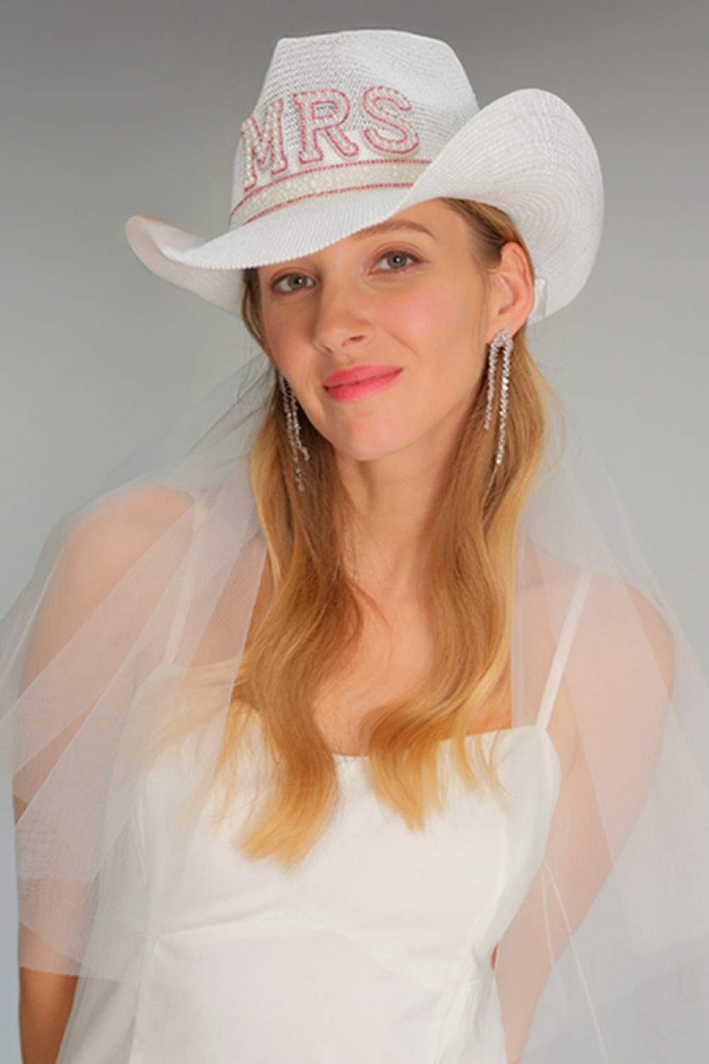 Hot Pink Elevate your western style with this stunning C.C MRS cowboy hat, featuring elegant pearl and rhinestone trim detailing. Crafted from a breathable blend of 60% paper and 40% polyester, this hat offers comfort and durability for all-day wear. Designed with a 22.5" circumference to fit most head sizes, the hat features a 3.25" brim and 4.75" tall crown for a classic, flattering silhouette. The decorative letter embellishment and sparkling rhinestone accents add a touch of glamour to any outfit, makin