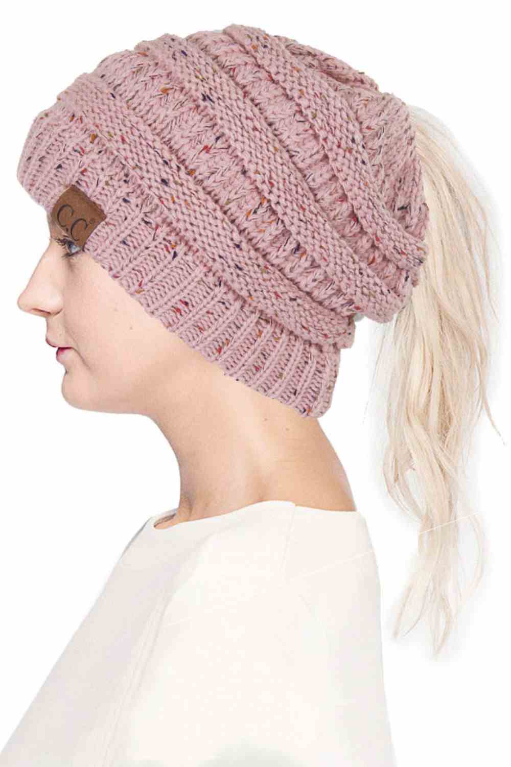 Pink The C.C Confetti Ponytail Messy Bun Beanie features a soft knit design with subtle confetti flecks for a fun, playful look. Designed with a convenient opening for ponytails or messy buns, it keeps you warm while allowing you to style your hair comfortably.