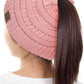Indi Pink The C.C Solid Color Ponytail Messy Bun Beanie combines comfort with versatility for effortless everyday style. Crafted from 100% soft acrylic, this beanie features an open crown design that accommodates ponytails and messy buns while keeping you warm. The one-size-fits-most construction ensures a secure, flattering fit for virtually anyone. Perfect for casual outings, workouts, or relaxed weekends, this practical accessory transitions seamlessly from season to season.