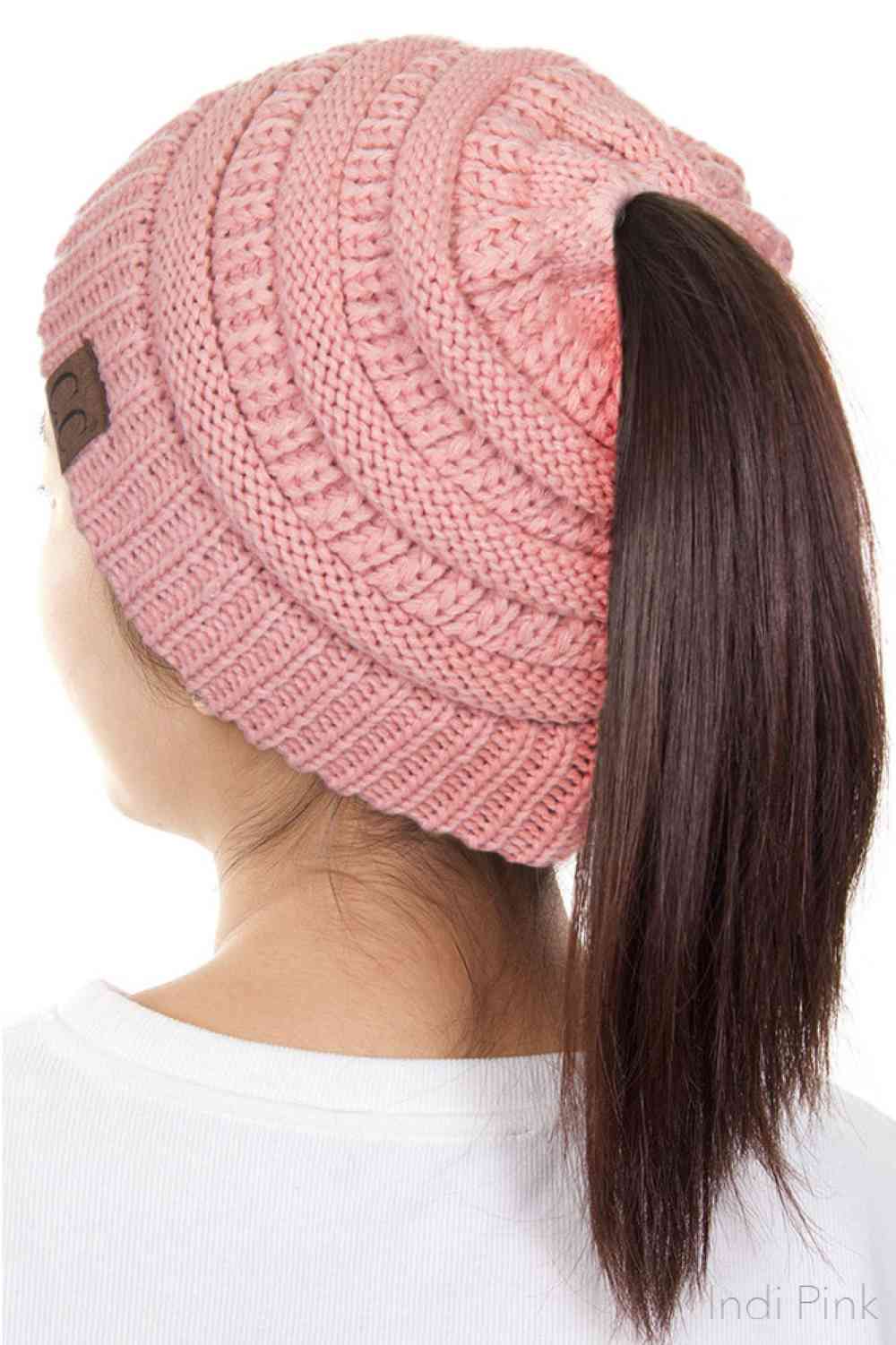 Indi Pink The C.C Solid Color Ponytail Messy Bun Beanie combines comfort with versatility for effortless everyday style. Crafted from 100% soft acrylic, this beanie features an open crown design that accommodates ponytails and messy buns while keeping you warm. The one-size-fits-most construction ensures a secure, flattering fit for virtually anyone. Perfect for casual outings, workouts, or relaxed weekends, this practical accessory transitions seamlessly from season to season.
