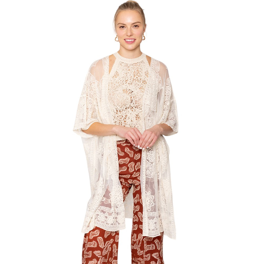Ivory Flower Lace Kimono Poncho is a versatile and fashionable addition to any wardrobe. The delicate lace detailing adds a touch of elegance, while the kimono style allows for comfortable and easy wear. Perfect for dressing up any outfit, this poncho is a must-have for any fashion-forward individual. 
