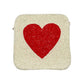 Ivory Heart accented crossbody bag is adorned with delicate seed beads, adding a touch of elegance to any outfit. The compact square shape is perfect for carrying your essentials, while the crossbody strap keeps your hands free. The unique design and quality materials make it a must-have accessory for any fashion-forward individual.