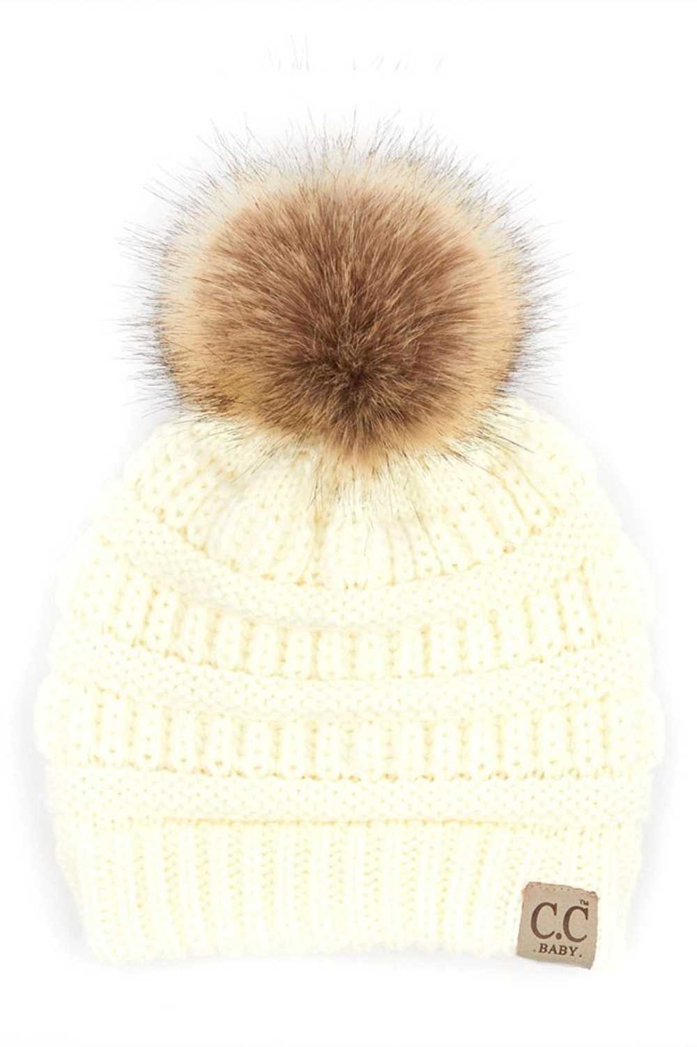 Ivory Keep your little one warm and cozy with this C.C Solid Ribbed Infant Beanie. Made from 100% acrylic, the soft ribbed knit construction provides gentle comfort against delicate skin while the natural fur pom adds a charming detail.