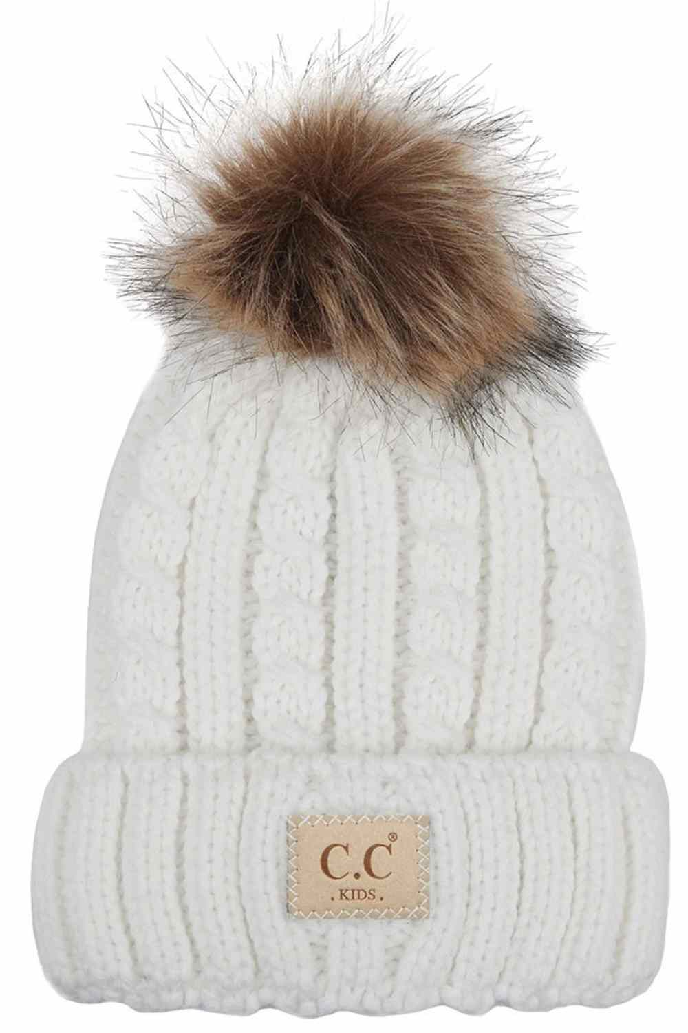 Ivory Keep your little one cozy and cute with this C.C Kids Beanie featuring a ribbed knit design and natural faux fur pom. Made from 100% acrylic, it delivers soft warmth perfect for chilly days while the plush pom adds playful charm.