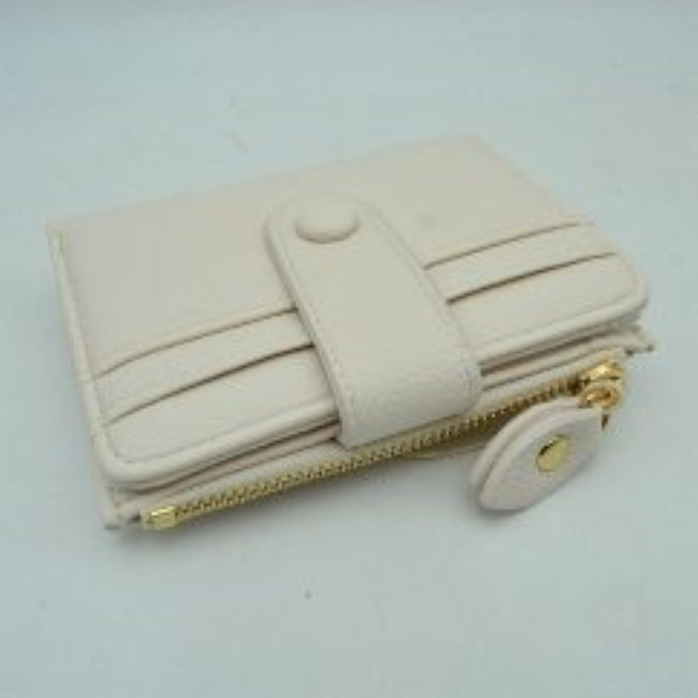 Ivory This compact card holder wallet features a textured pebbled exterior in a soft beige tone, providing a sleek and practical design for daily organization. The front panel is equipped with multiple exterior card slots secured by a matching leather strap with a snap button closure. A secure side pocket with a metallic gold-tone zipper and a detailed leather pull tab opens to an internal compartment for coins or folded bills, making it an essential companion for minimalist carrying.