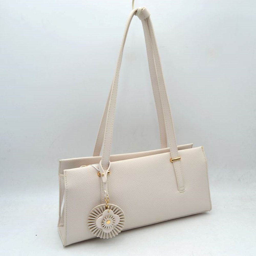 Ivory Upgrade your everyday style with this sleek and sophisticated black shoulder tote bag. Designed with a modern rectangular silhouette, this handbag combines elegance and practicality for daily use. Crafted from textured faux leather, it features comfortable shoulder straps, a spacious interior, and a stylish decorative charm for a fashionable finishing touch. Perfect for work, shopping, casual outings, or evening occasions, this versatile bag complements both formal and casual wardrobes.