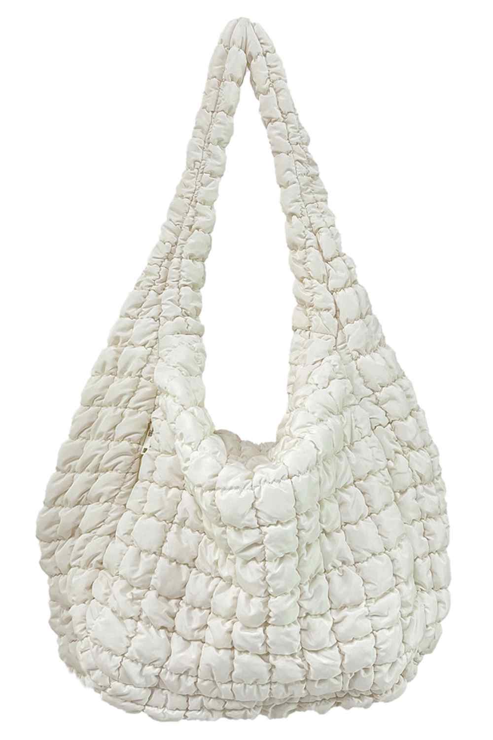 Ivory Spacious quilted bag designed for everyday carry and travel. Features a durable 100% polyester construction with a quilted exterior for added protection and style. Generous dimensions of 17.7" x 19.7" x 8.7" provide ample room for essentials, making it perfect for shopping, work, or weekend getaways. Lightweight and easy to maintain. Made in China.