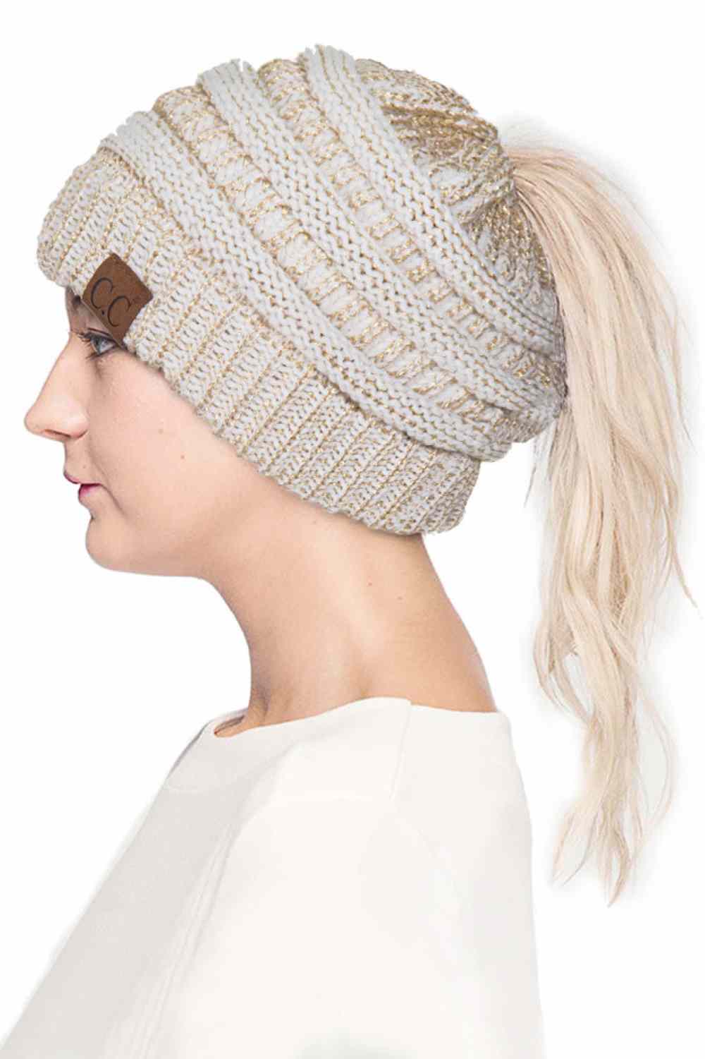 Ivory Gold Stay cozy and stylish with the C.C Metallic Messy Bun Ponytail Beanie, designed for effortless everyday wear. Crafted from 100% acrylic, this lightweight beanie features a sleek metallic finish that adds a modern touch to any outfit.