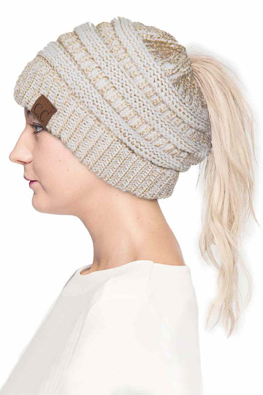 Ivory Gold Stay cozy and stylish with the C.C Metallic Messy Bun Ponytail Beanie, designed for effortless everyday wear. Crafted from 100% acrylic, this lightweight beanie features a sleek metallic finish that adds a modern touch to any outfit.