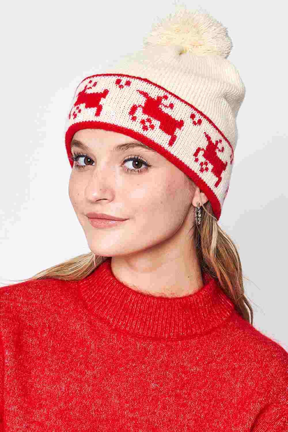 Ivory Reindeer Christmas Holiday Pom Beanie features festive reindeer detailing topped with a fluffy pom for a cheerful, winter-ready holiday look. Designed with a soft stretch fit, it keeps you warm and cozy while adding playful seasonal charm to your cold-weather outfits.