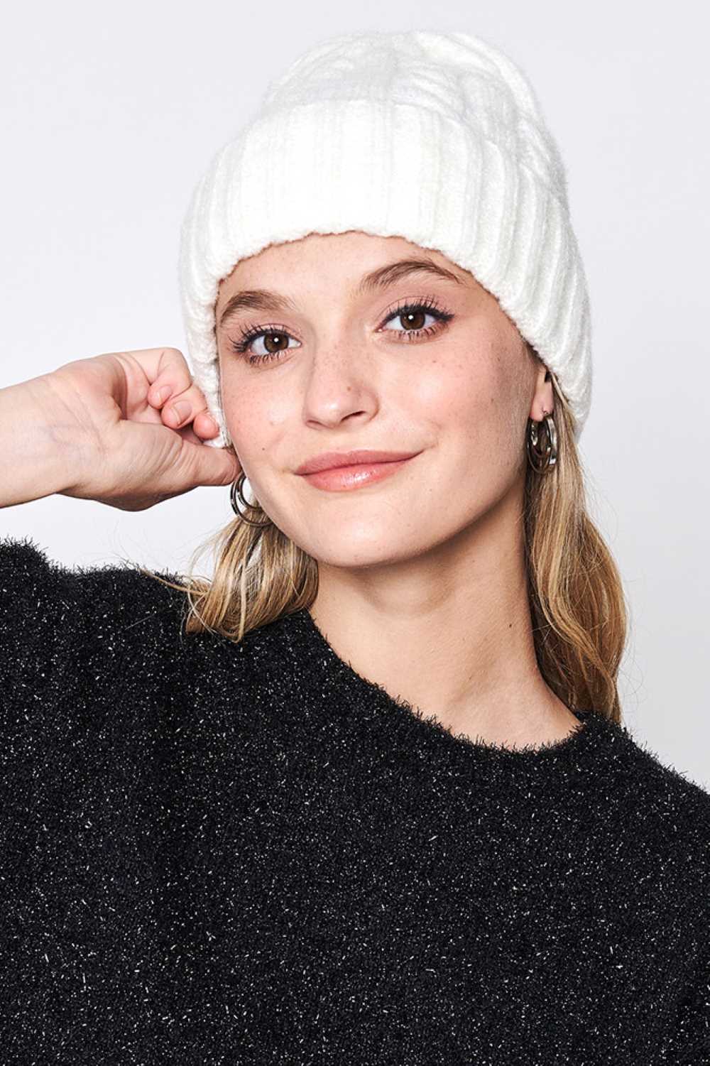 Ivory Solid Cable Knit Beanie features a classic cable-knit texture in a clean, solid design for a timeless cold-weather look. Crafted with a soft stretch fit, it delivers cozy warmth and everyday comfort while effortlessly complementing any winter outfit.