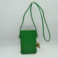Kell green This compact vertical crossbody bag is designed for everyday functionality with a distinct woven textured pattern across its body. It features a slim, continuous cord strap attached securely to the sides with visible knot details for comfortable carrying. A clean horizontal opening at the top allows effortless access to the main storage compartment