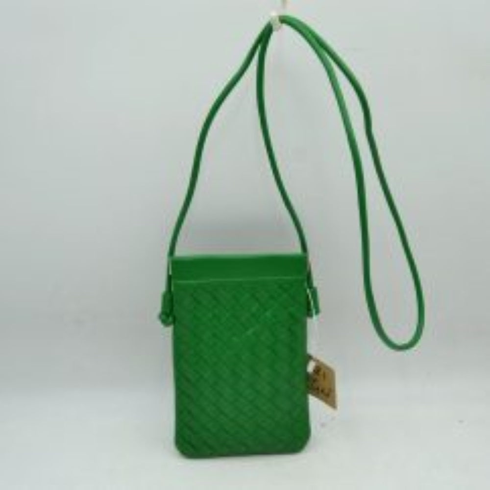 Kell green This compact vertical crossbody bag is designed for everyday functionality with a distinct woven textured pattern across its body. It features a slim, continuous cord strap attached securely to the sides with visible knot details for comfortable carrying. A clean horizontal opening at the top allows effortless access to the main storage compartment
