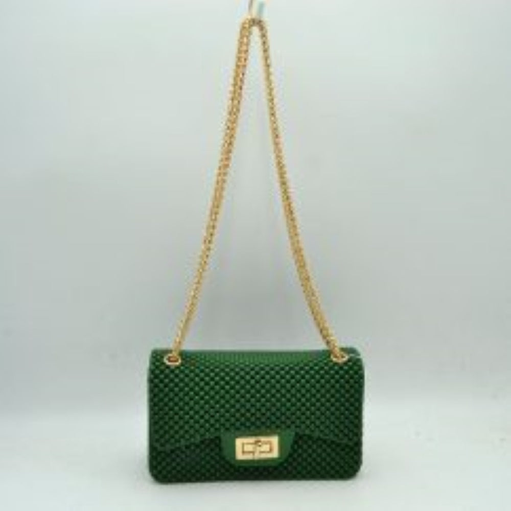 Kelly Green This rectangular flap bag showcases a distinctive all-over bumpy textured design that adds unique tactile interest, making it a stylish choice for everyday use. The main storage compartment is safely secured by a front flap featuring a metallic twist-lock closure. Designed for easy carrying, the bag incorporates a long metallic chain shoulder strap fed through top eyelets, allowing it to rest comfortably on the shoulder throughout the day.