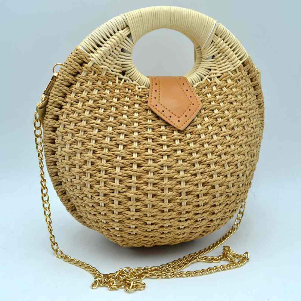 Khaki Bring a chic, geometric flair to your summer style with this stunning round woven basket bag. Showcasing an eye-catching circular silhouette and rich, multi-tonal straw weaving, this handbag is the quintessential accessory for resort getaways, beach days, or sunny afternoon strolls. Blending bohemian textures with elegant hardware accents, it serves as a versatile piece that easily elevates a breezy maxi dress or a casual linen ensemble.