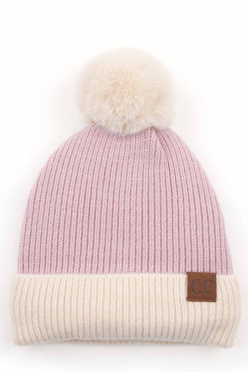Lavneder The C.C Solid Color Pom Beanie with Beige Cuff features a classic solid knit design accented by a contrasting beige cuff for a stylish, modern touch. Topped with a fluffy pom and crafted from soft, stretchy fabric, it delivers cozy warmth and a comfortable fit for chilly days.