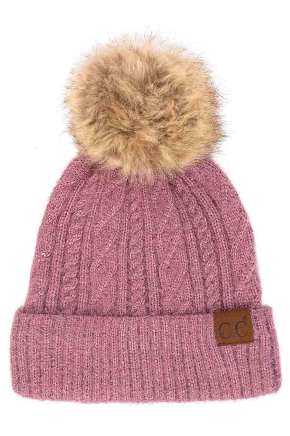 Lavender The C.C Soft Cuff Beanie in Mixed Cable Pattern with Faux Fur Pom features a stylish blend of cable-knit textures topped with a plush faux fur pom for a chic winter look. Made from soft, stretchy fabric with a cozy cuff, it provides warmth, comfort, and a snug fit for cold-weather wear.