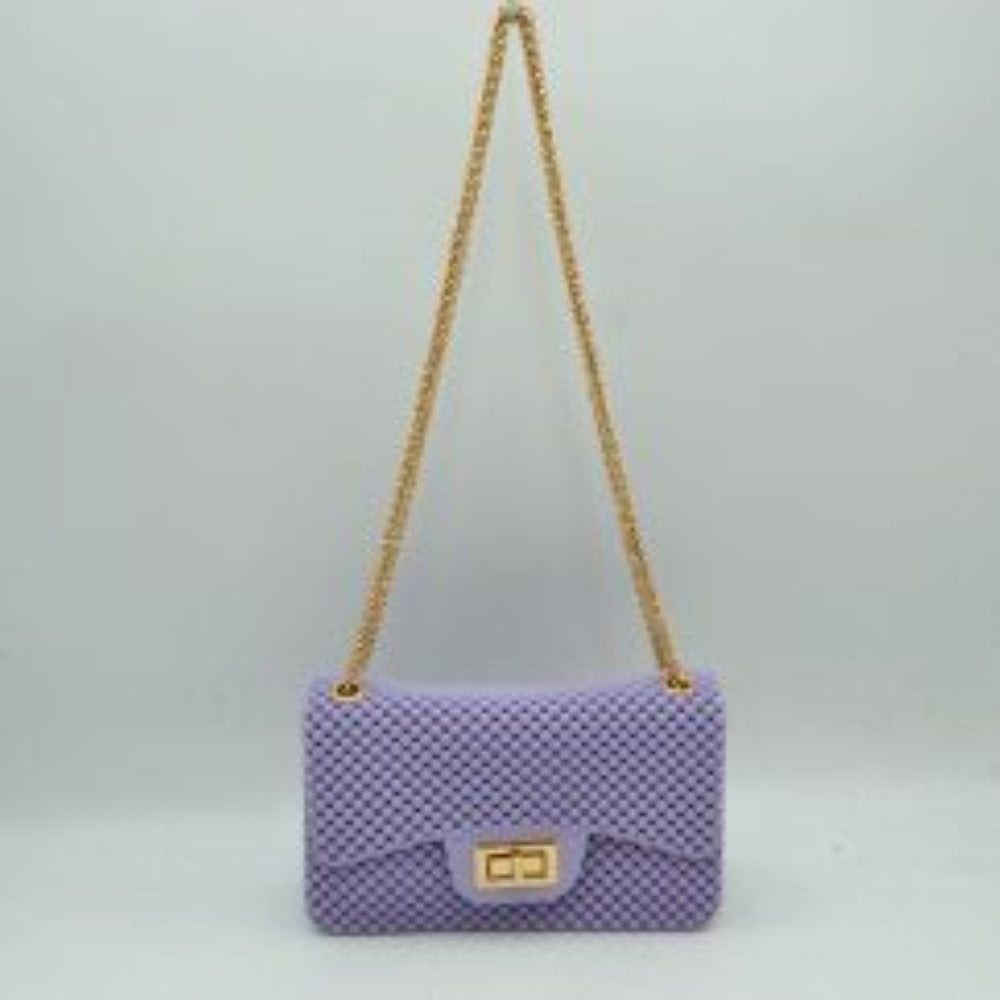 Lavender This rectangular flap bag showcases a distinctive all-over bumpy textured design that adds unique tactile interest, making it a stylish choice for everyday use. The main storage compartment is safely secured by a front flap featuring a metallic twist-lock closure. Designed for easy carrying, the bag incorporates a long metallic chain shoulder strap fed through top eyelets, allowing it to rest comfortably on the shoulder throughout the day.