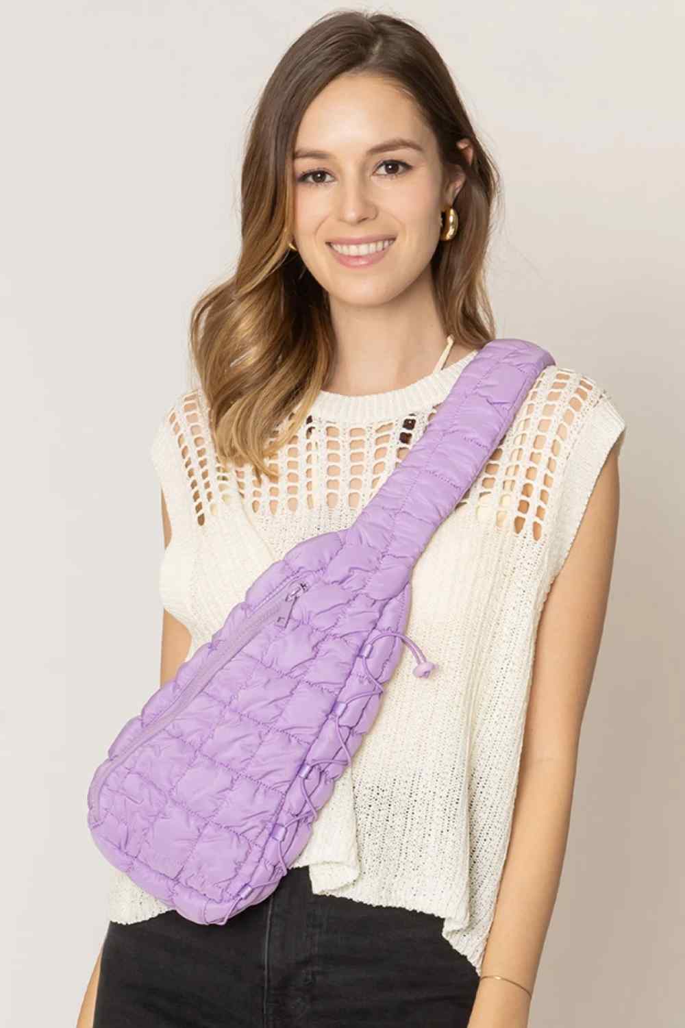 Lavender Carry your essentials in style with this Solid Quilted Sling Bag. Crafted from durable 100% polyester with a classic quilted design, it offers a sleek, versatile look that complements any outfit. The adjustable sling strap allows for comfortable crossbody wear, making it perfect for everyday errands, travel, or casual outings. One size fits all