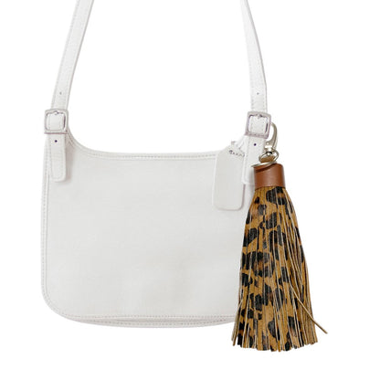 Leopard Leopard Patterned Genuine Leather Tassel Bag Charm adds a stylish touch to any bag with its trendy leopard pattern. Made from high-quality leather, it's a durable and chic accessory that enhances the look of your bag. Elevate your style with this must-have bag charm. 