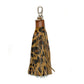 Leopard Patterned Genuine Leather Tassel Bag Charm adds a stylish touch to any bag with its trendy leopard pattern. Made from high-quality leather, it's a durable and chic accessory that enhances the look of your bag. Elevate your style with this must-have bag charm. 