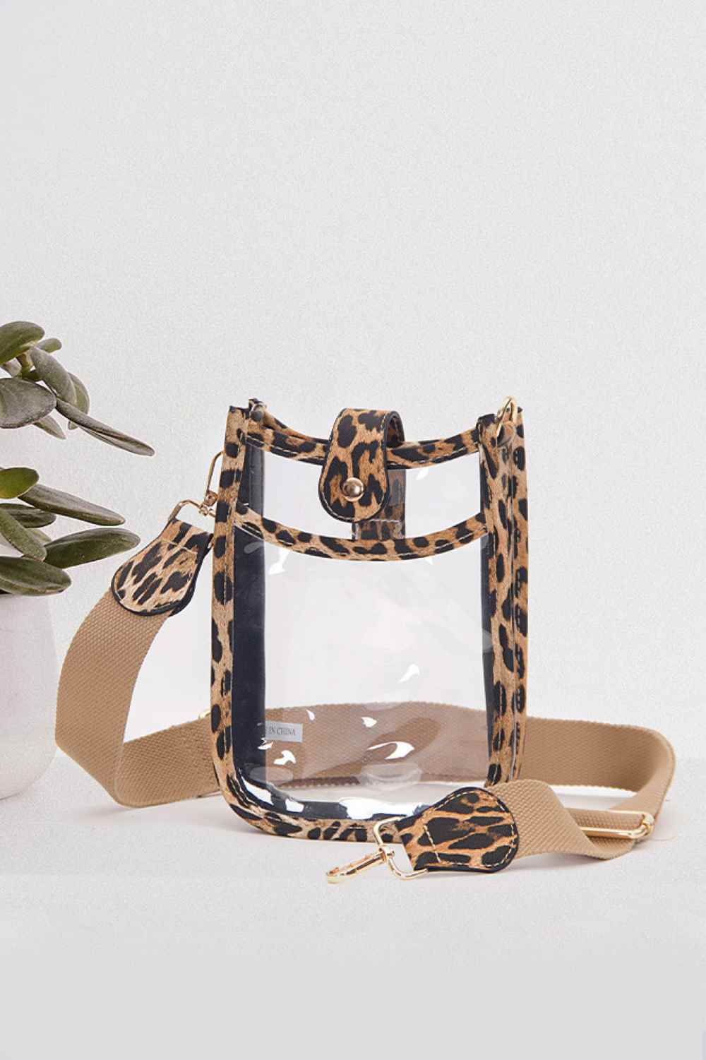 Leopard Perfect for concert season and stadium events, this clear crossbody mini bag meets all venue security requirements while keeping your essentials within reach. Crafted from durable 100% PVC, it's easy to clean and built to last through countless outings. Compact yet functional at 8" x 5.8" x 2.3", the adjustable crossbody strap sits comfortably across your body, leaving your hands free. The transparent design lets you quickly locate your phone, keys, and small valuables at a glance.