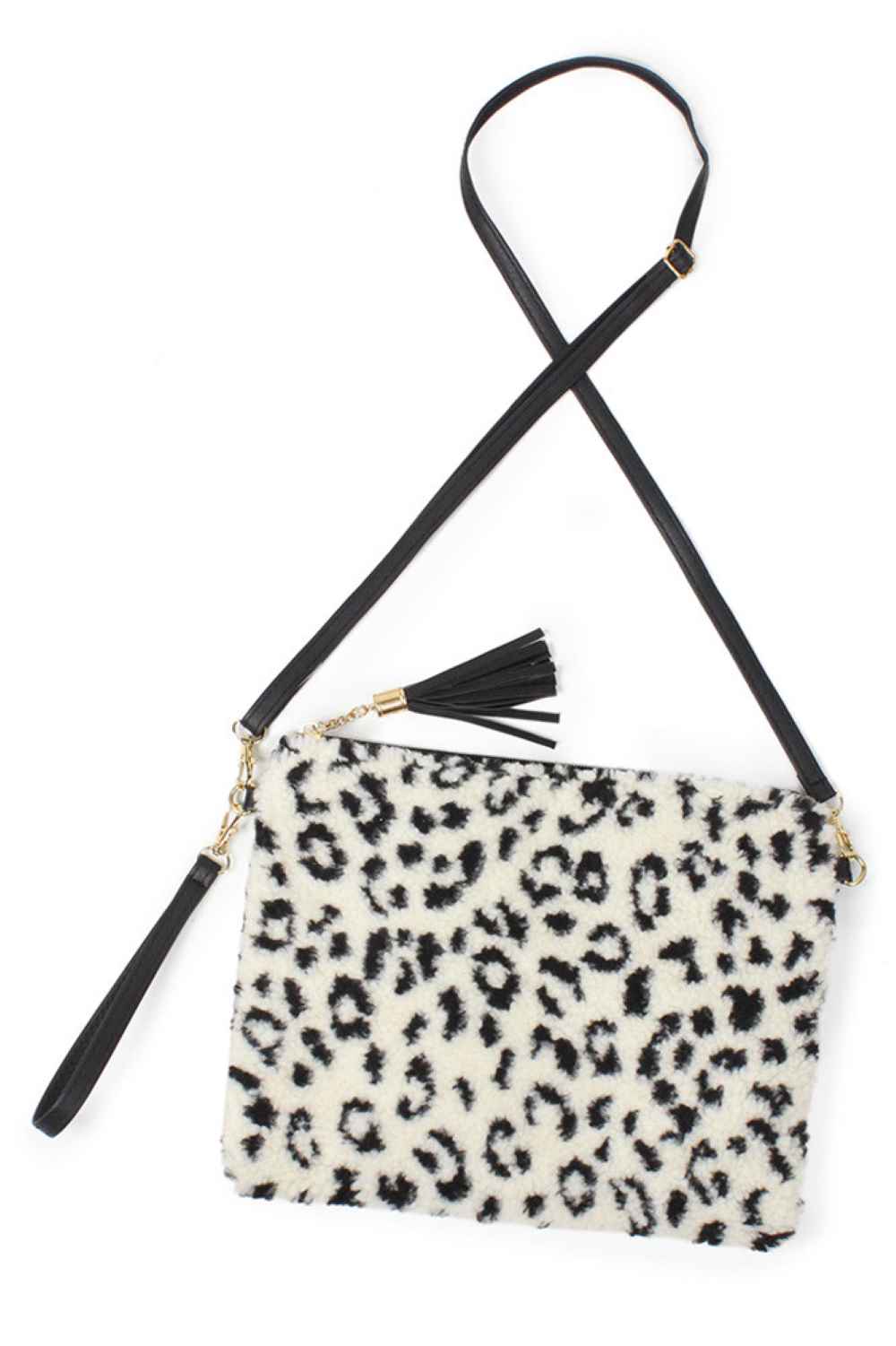 Leopard Elevate your everyday style with this striking Leopard Fur Crossbody Clutch Bag. Crafted from soft 100% polyester, it features a bold leopard print that adds instant edge to any outfit. The compact 11" x 8.5" size is perfect for carrying essentials while keeping your hands free. Designed with a crossbody strap for comfortable, hands-free wear, this versatile clutch transitions seamlessly from day to night. 