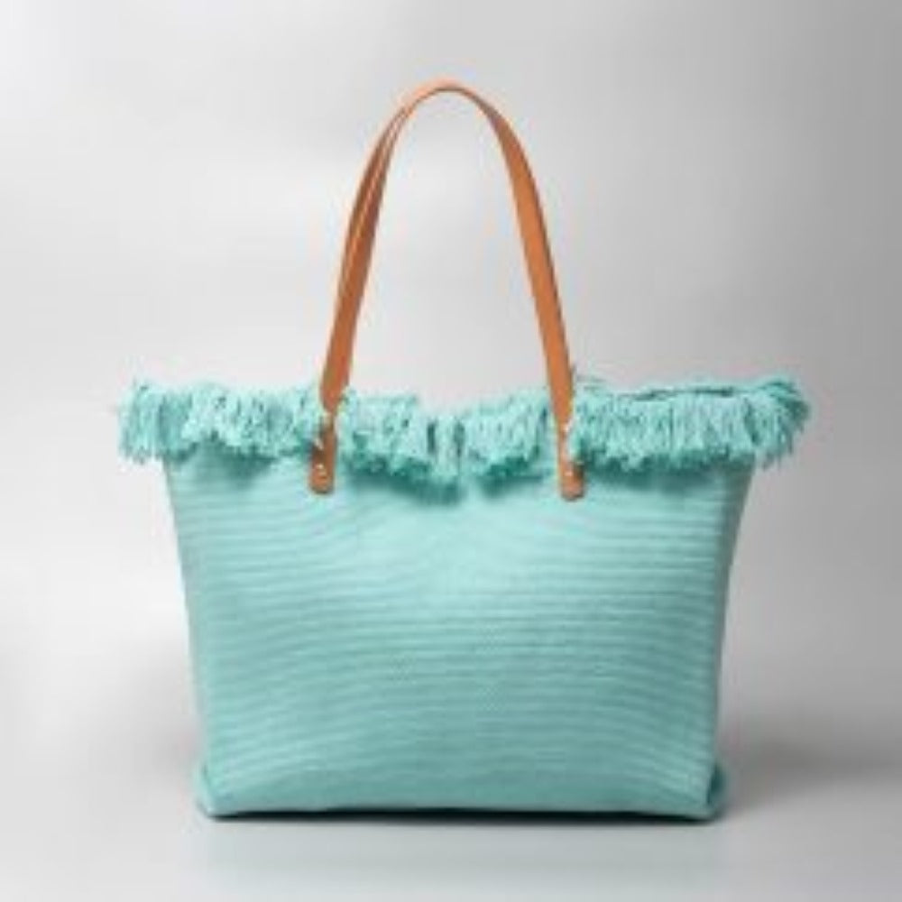 Light blue This spacious tote bag features a finely textured main body adorned with an eye-catching, voluminous fringe trim entirely wrapping around the upper opening. Designed for versatile everyday use, the bag is equipped with dual flat shoulder straps anchored securely to the front and back panels by metallic rivets.