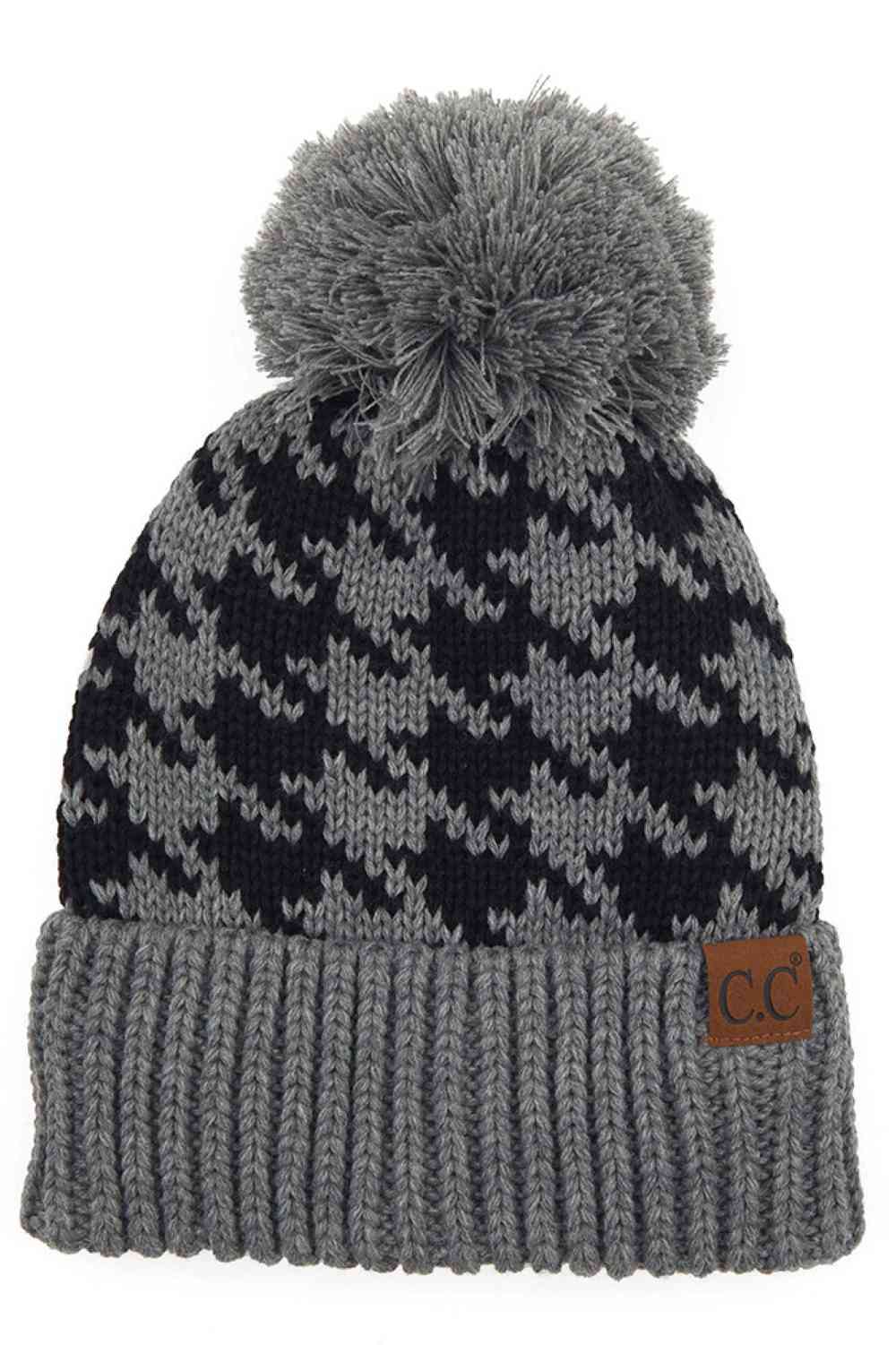 Light Grey Elevate your winter wardrobe with the C.C Houndstooth Knit Beanie With Pom. This classic houndstooth pattern beanie combines timeless style with everyday comfort. Made from 100% acrylic, it's lightweight and soft against your skin. The playful pom-pom adds a charming finishing touch.